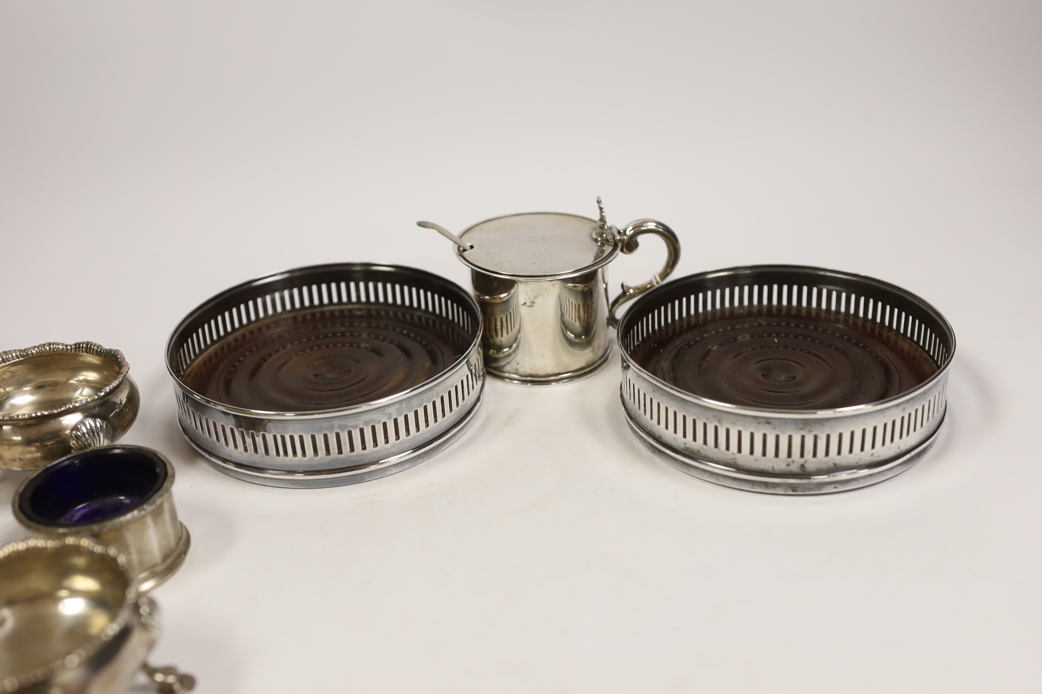 An early Victorian Scottish silver drum mustard, Edinburgh, 1844?, 7cm, two pairs of silver salts including pair by David & Robert Hennell, London, 1766 and a pair of silver plated wine coasters.